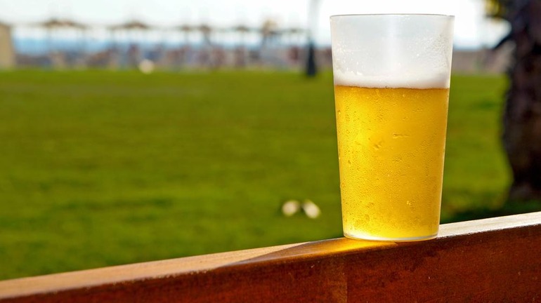 Beer glass on a cricket field, blending sports and leisure