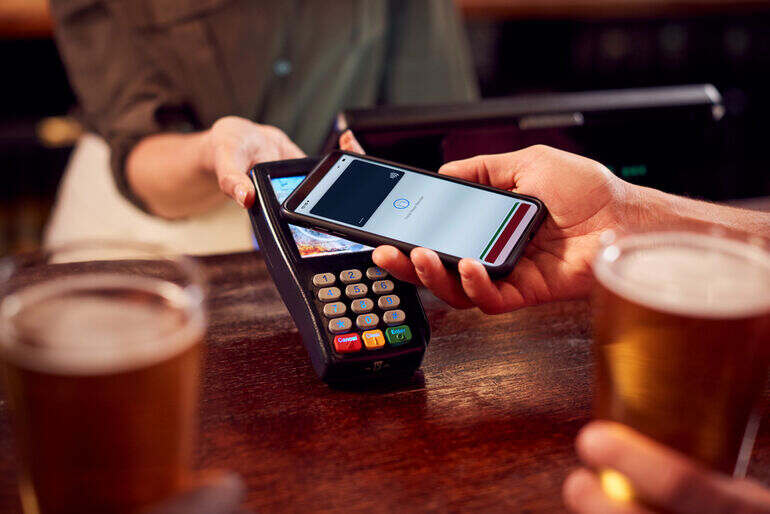 A customer makes a mobile payment for a homebrew