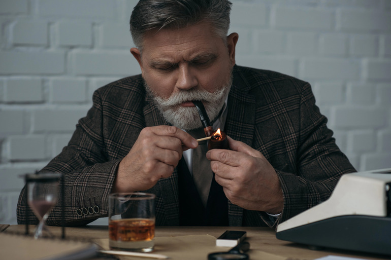 Man holding a portable glass pipe