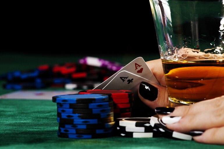 Casino enthusiast with casino chips and cards while enjoying a homebrewed craft beer