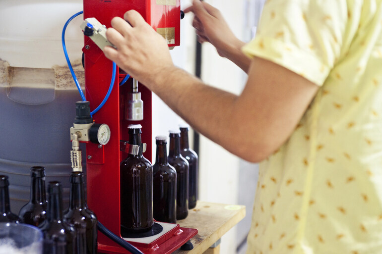 A homebrewer bottling beer in a brewing setup, optimizing the process with a food orientation system