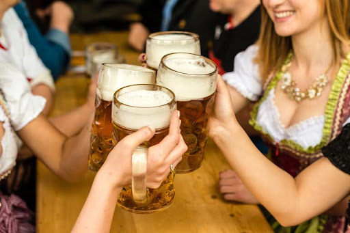 Four women enjoying glasses of beer together in an occasion