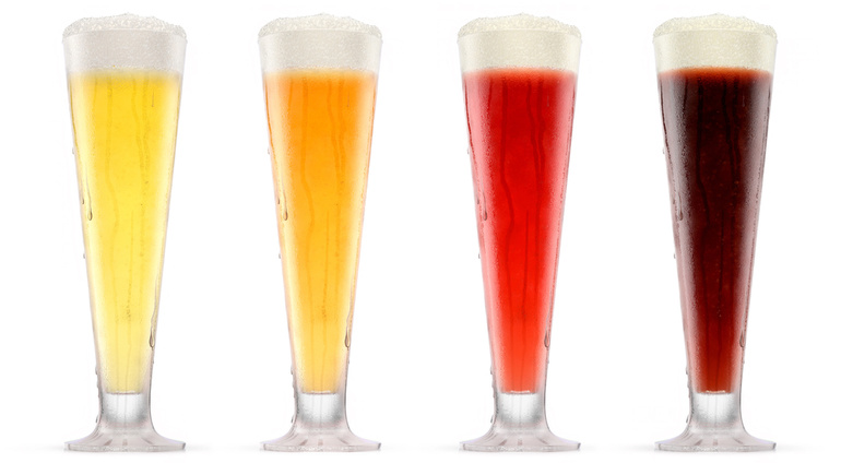 Set of glasses of fresh beer with bubble froth isolated on white