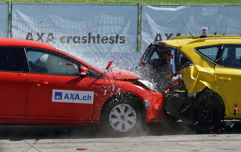 A red car colliding into a yellow car in Colorado