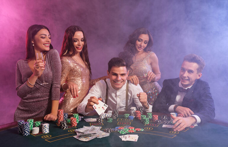 Group of elegantly dressed people playing poker at a casino in Poland