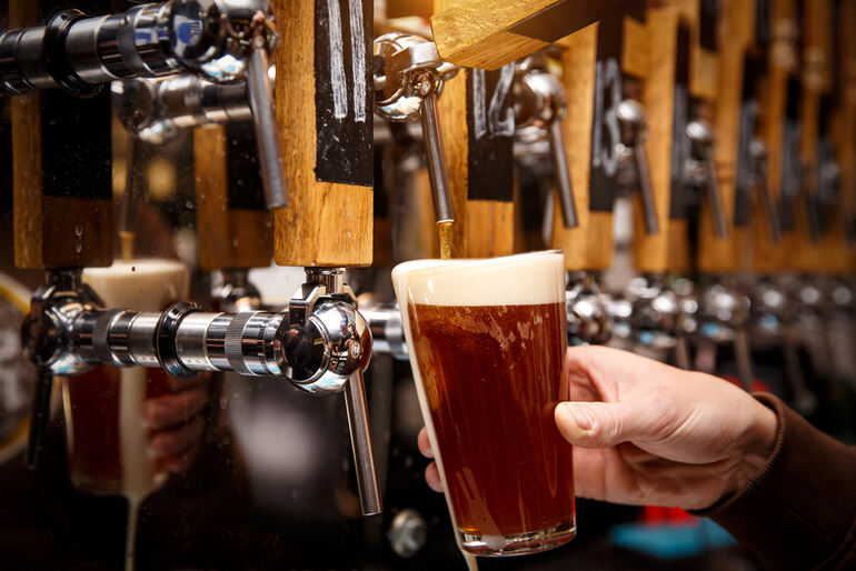 Someone pouring beer from a POS system