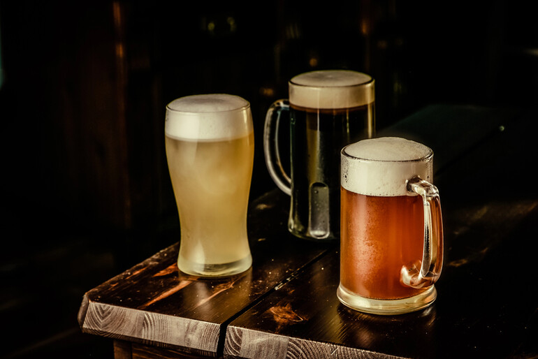 Three distinct styles of homebrews in glasses in a homebrew club