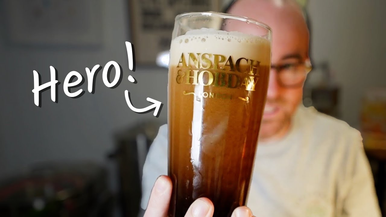 Jonny Garrett holds pint of beer in hand