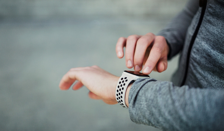 A man wearing an AI-powered smartwatch and interacting with it