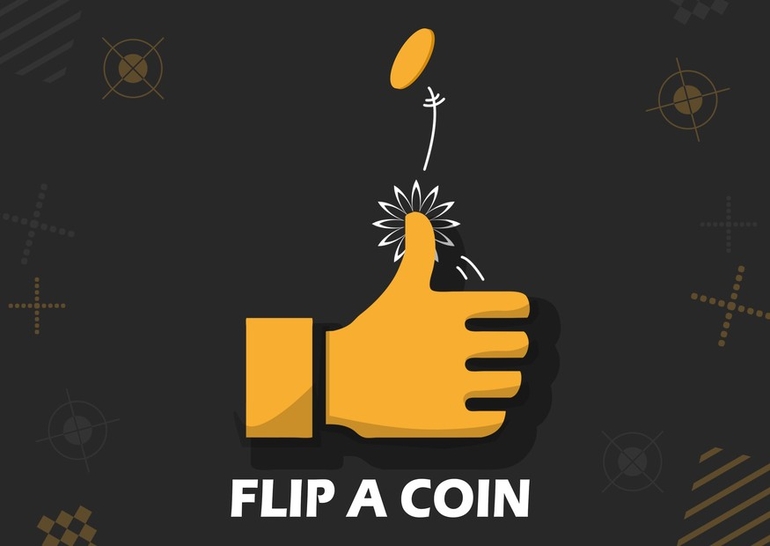 A hand flipping a coin.