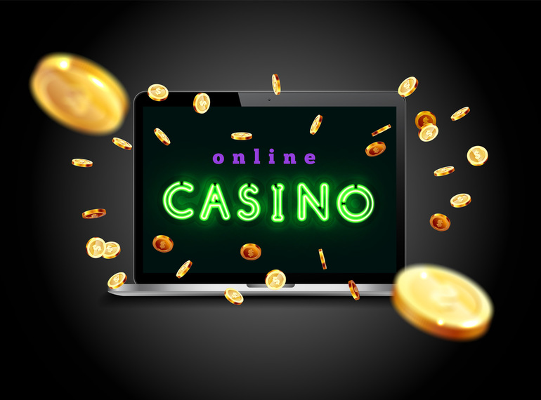 Online casino on laptop screen with flying gold coins