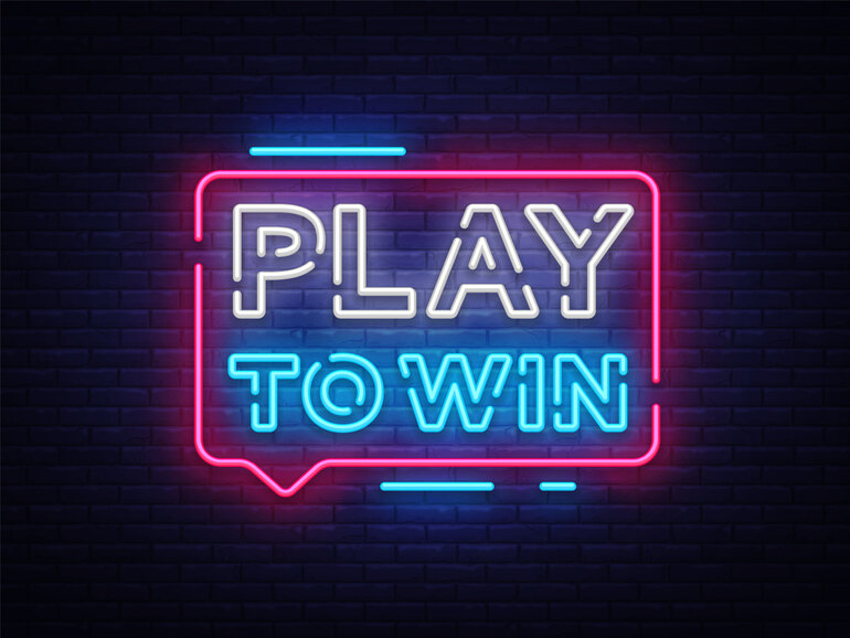 A neon sign glowing with the platform’s bold 'Play to Win' strategy