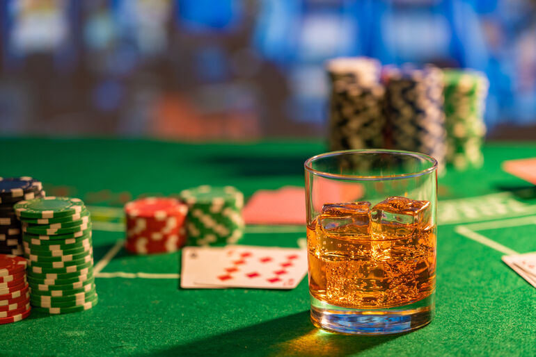 An alcoholic drink is served in a casino