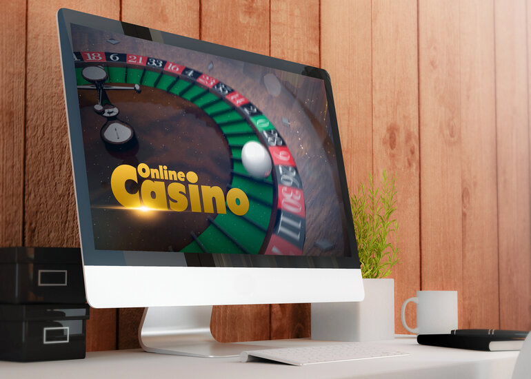Modern workspace with a computer displaying online casino roulette