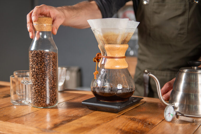 A skillful barista meticulously brewing coffee using a Chemex